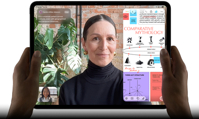 iPad Pro, front exterior, landscape orientation, space black color, rounded corners, black display bezel, hands holding left and right sides, display showing a FaceTime conversation being live translated, and an educational app showing a presentation of "Comparative Mythology" with text, diagrams, and handwritten notes