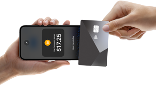 A hand holds iPhone 16e, on-screen: shopping bag icon, Pay Community Market, $17.25, Hold Here to Pay, another hand touches credit card with Tap to Pay icon to phone