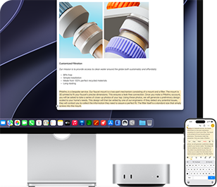 Mac mini front, tucked under Studio Display, an iPhone sits to the right of the device and the display, text selected with cut, copy, paste, and AutoFill commands above on iPhone matches highlighted text on display, showcasing Universal Clipboard