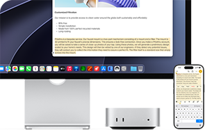 Mac mini front, tucked under Studio Display, an iPhone sits to the right of the device and the display, text selected with cut, copy, paste, and AutoFill commands above on iPhone matches highlighted text on display, showcasing Universal Clipboard