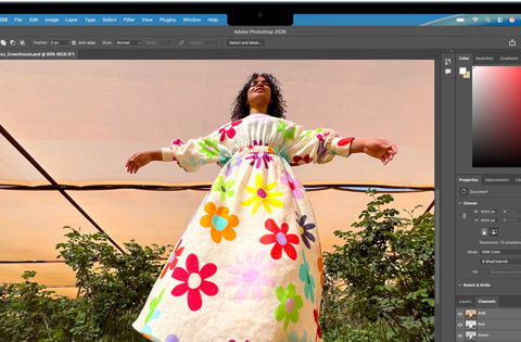 MacBook Air, screen shows an Adobe Photoshop window displaying a photo of a woman in a colorful floral dress, to showcase the brightness of the Liquid Retina display