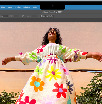 MacBook Air, screen shows an Adobe Photoshop window displaying a photo of a woman in a colorful floral dress, to showcase the brightness of the Liquid Retina display