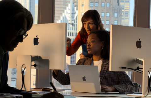 People working in an office using several screens at once, to demonstrate that you can connect MacBook Air to external displays