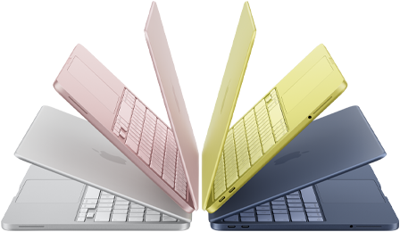 MacBook Neo laptops in silver, blush, citrus, and indigo colors, slightly open and arranged in an arch formation