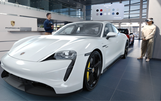 A customer in a Porsche showroom views a realistic 3D projection of a white sportscar with Apple Vision Pro and talks with an employee about color options displayed above the car
