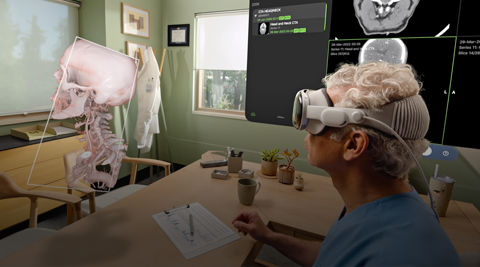 A doctor uses Apple Vision Pro to look at a 3D projection of X-rays and a human skull