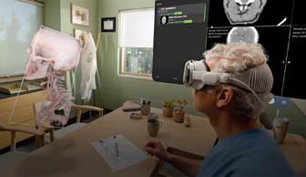A doctor uses Apple Vision Pro to look at a 3D projection of X-rays and a human skull
