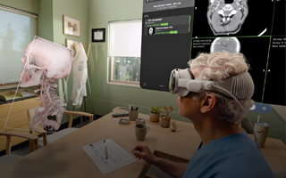 A doctor uses Apple Vision Pro to look at a 3D projection of X-rays and a human skull