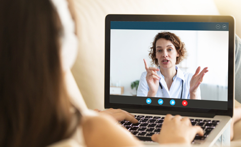 Telehealth: woman talking to doctor on a laptop.